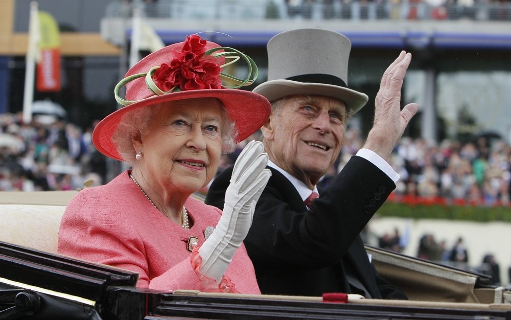 FILE - In this Thursday June, 16, 2011 file photo Britain's Queen Elizabeth II with Prince Philip arrive by horse drawn carriage in the parade ring on the third day, traditionally known as Ladies Day, of the Royal Ascot horse race meeting at Ascot, England. Buckingham Palace says Prince Philip, husband of Queen Elizabeth II, has died aged 99. (AP Photo/Alastair Grant, File)